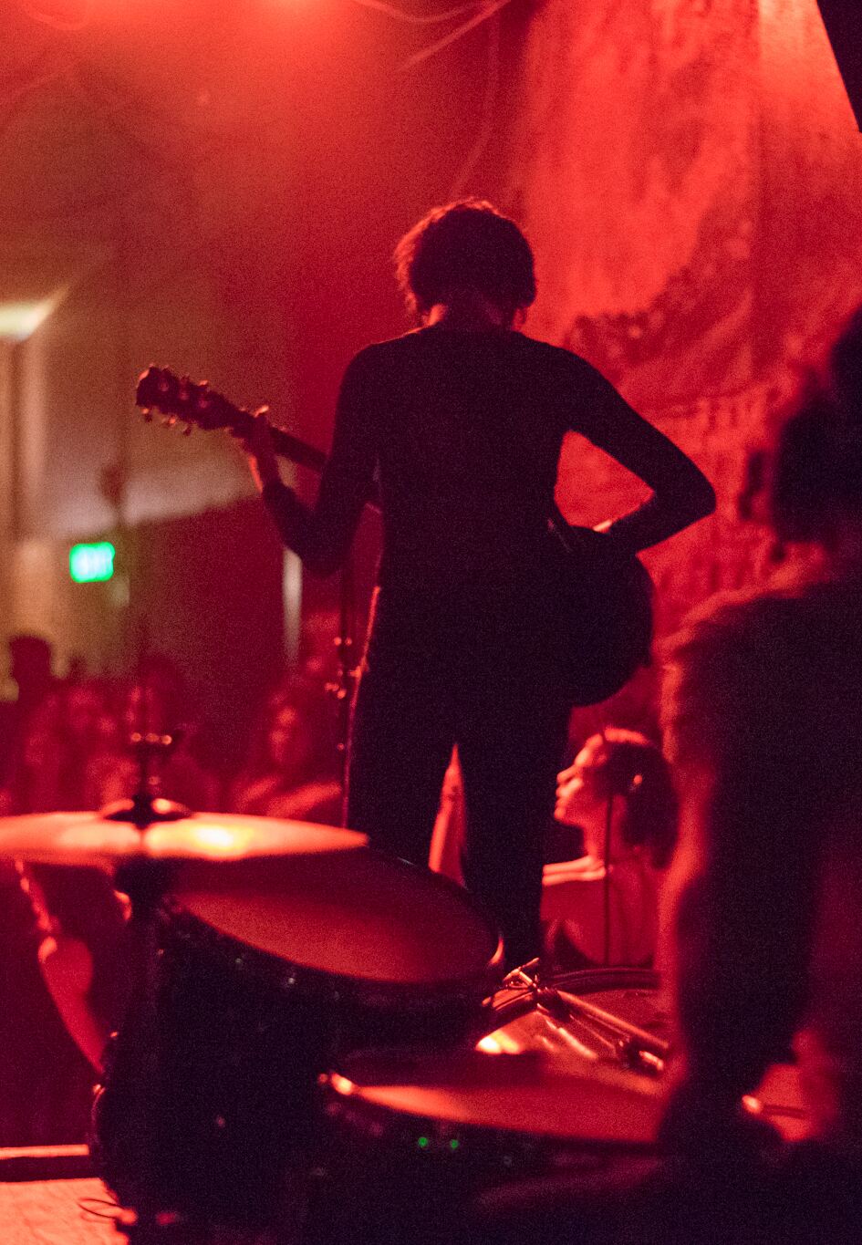 Guitarist silhouetted in red stage light at The Smell, downtown Los Angeles